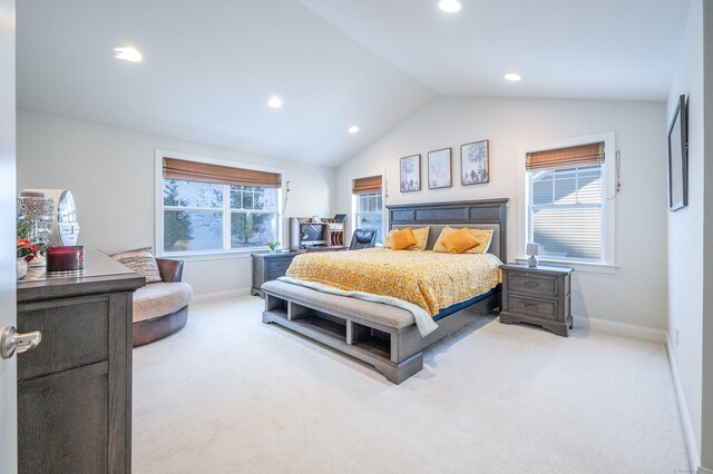 carpeted bedroom featuring multiple windows and lofted ceiling