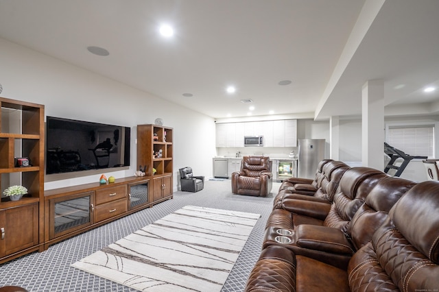 carpeted living area with recessed lighting and visible vents