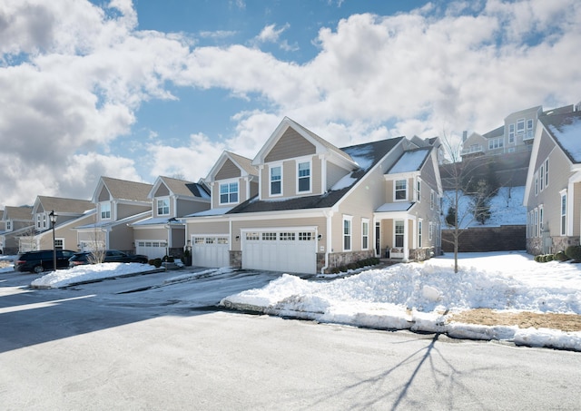 view of front of property with an attached garage, a residential view, and stone siding