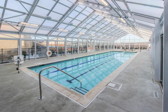 community pool with a lanai and a patio area