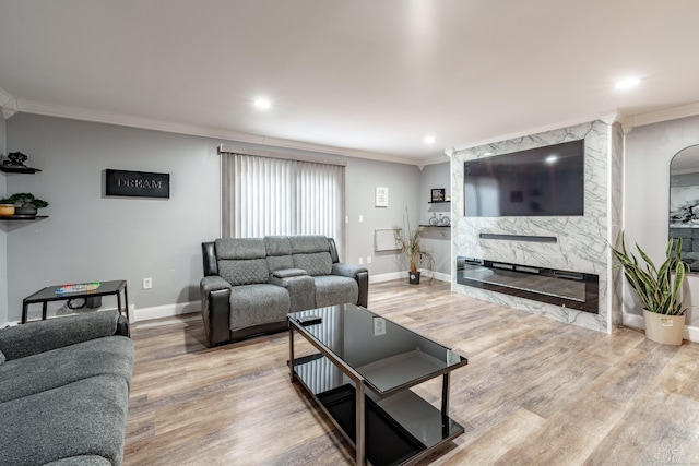 living room featuring a premium fireplace, ornamental molding, and hardwood / wood-style floors