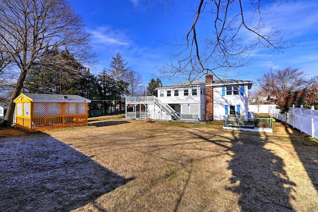 rear view of house featuring an outdoor structure