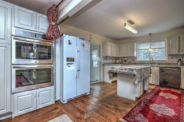 kitchen with white cabinets, dishwasher, stainless steel double oven, and white refrigerator with ice dispenser