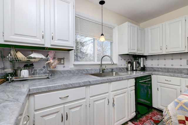 kitchen featuring white cabinets, dishwasher, sink, and decorative light fixtures