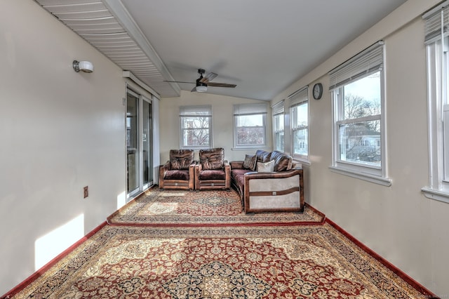 sunroom / solarium with ceiling fan and vaulted ceiling