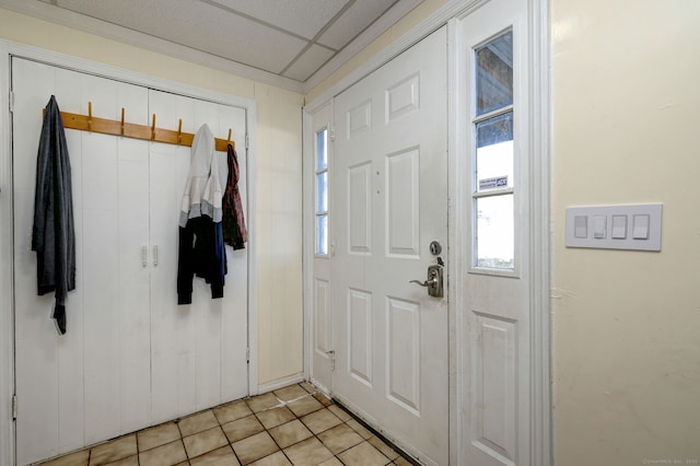 entrance foyer with a paneled ceiling and light tile patterned flooring