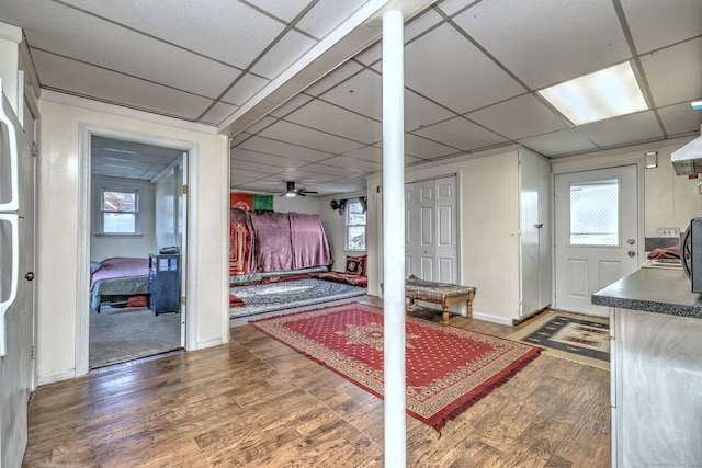 bedroom with dark hardwood / wood-style flooring and a drop ceiling