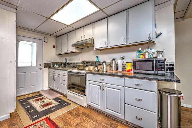 kitchen featuring white range with electric stovetop, a paneled ceiling, white cabinetry, and dark hardwood / wood-style floors