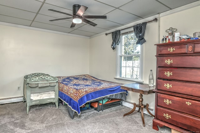 carpeted bedroom featuring ceiling fan, a drop ceiling, and a baseboard radiator