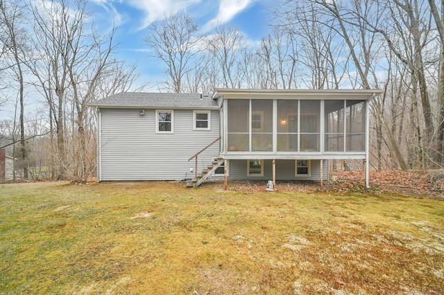 back of house featuring a sunroom and a yard