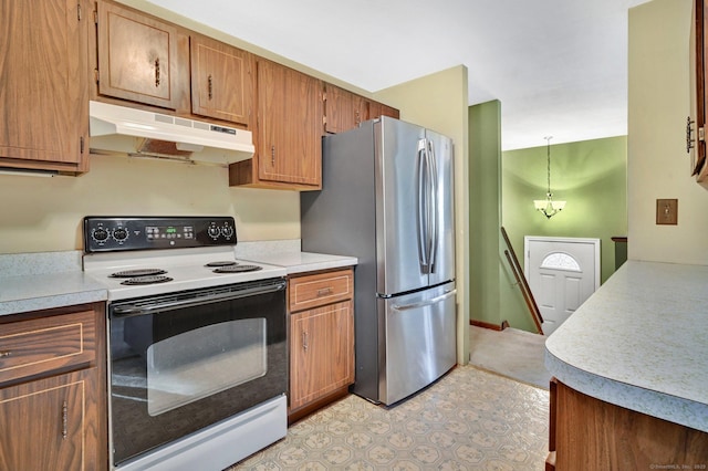 kitchen with pendant lighting, white electric stove, and stainless steel refrigerator