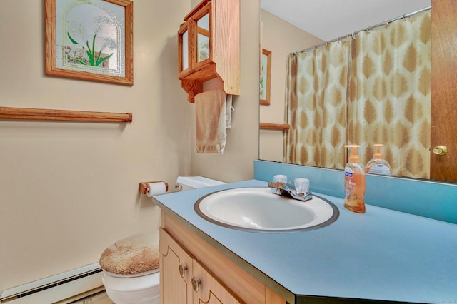 bathroom featuring toilet, baseboard heating, and vanity