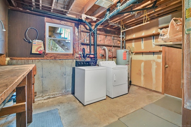 laundry room with electric water heater and independent washer and dryer