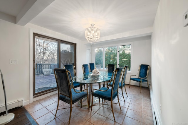 tiled dining space featuring an inviting chandelier and a baseboard heating unit