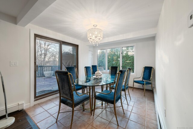 tiled dining space featuring an inviting chandelier and a baseboard heating unit