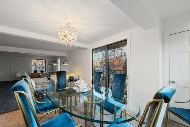 tiled dining space featuring an inviting chandelier