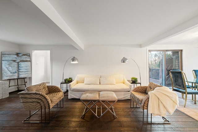 living room featuring beamed ceiling and dark hardwood / wood-style flooring