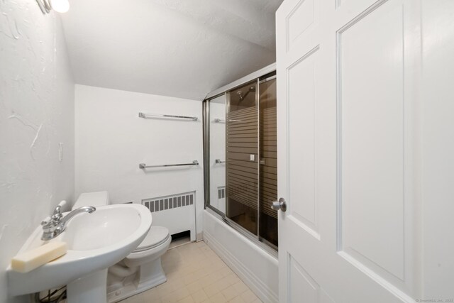 full bathroom with radiator, combined bath / shower with glass door, sink, toilet, and a textured ceiling