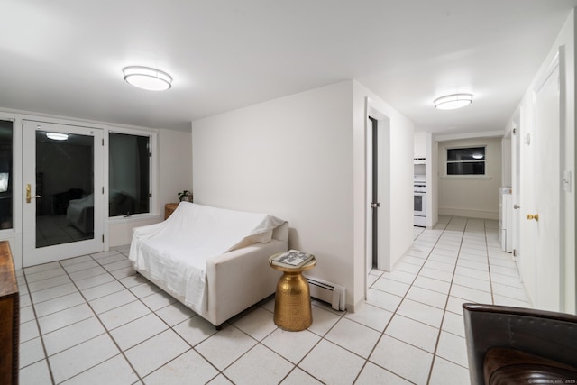 interior space featuring baseboard heating and light tile patterned flooring