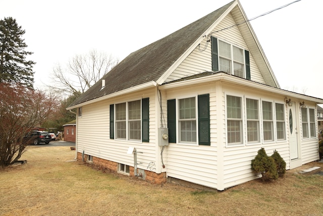 view of property exterior featuring a lawn