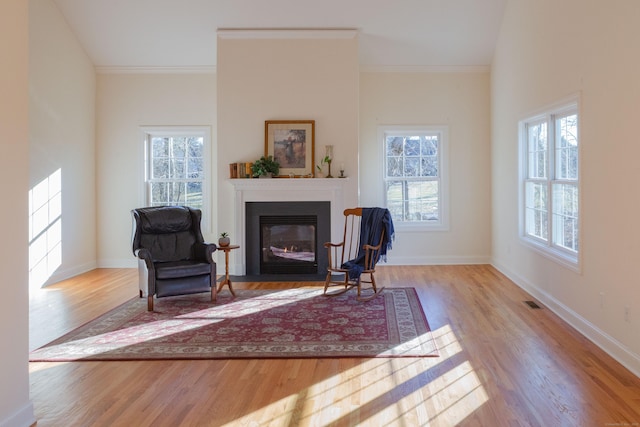 sitting room featuring ornamental molding and light hardwood / wood-style floors