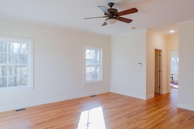 spare room with crown molding, ceiling fan, and light wood-type flooring