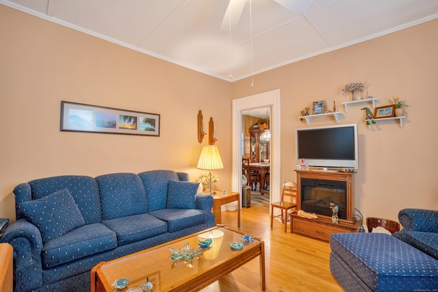 living room with hardwood / wood-style flooring and crown molding