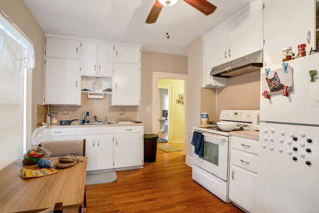 kitchen featuring white appliances, sink, hardwood / wood-style flooring, ceiling fan, and white cabinetry