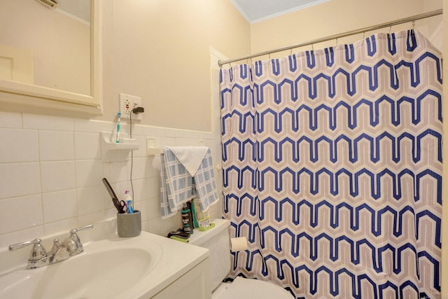 bathroom featuring vanity, crown molding, toilet, tile walls, and curtained shower