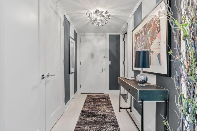 doorway featuring a notable chandelier and ornamental molding