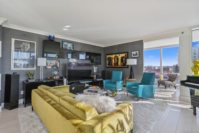 living room featuring ornamental molding and light wood-type flooring