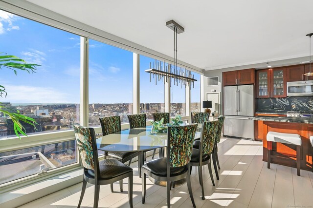 sunroom featuring a notable chandelier