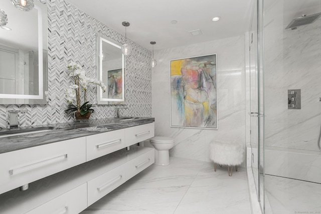 bathroom with a shower with shower door, tile walls, toilet, and vanity