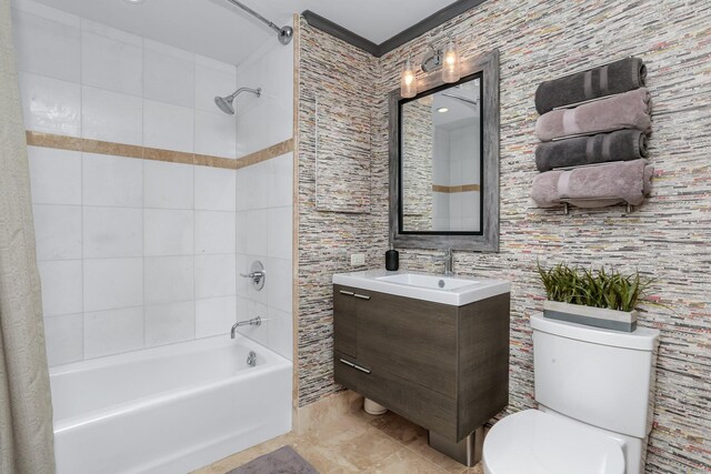 full bathroom with toilet, tiled shower / bath combo, tile patterned floors, and vanity