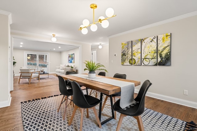 dining area featuring a chandelier, hardwood / wood-style flooring, and ornamental molding