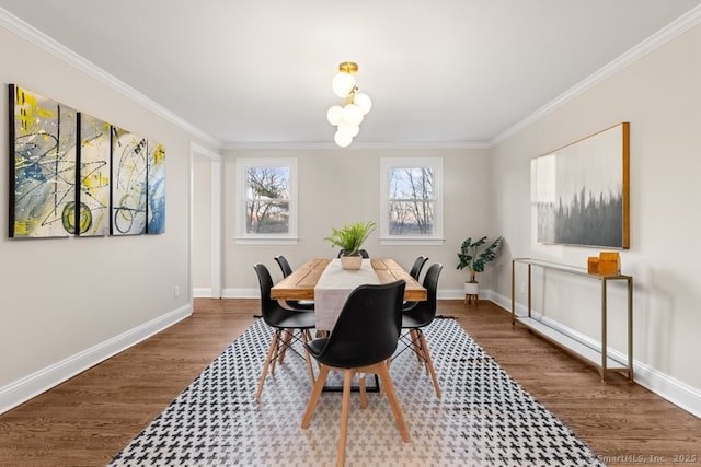 dining area featuring hardwood / wood-style flooring, crown molding, and a chandelier