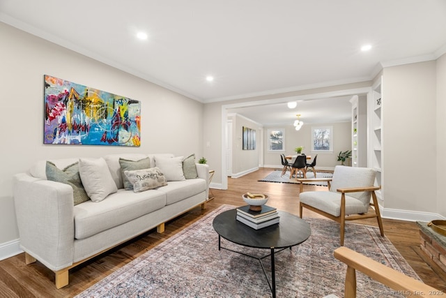 living room featuring crown molding and wood-type flooring