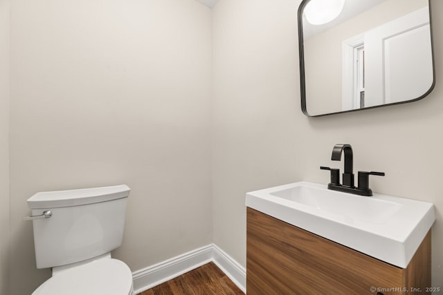 bathroom featuring hardwood / wood-style floors, vanity, and toilet