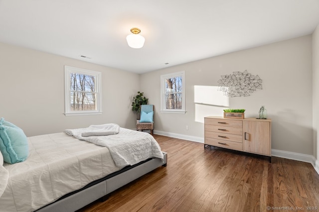 bedroom with dark hardwood / wood-style flooring