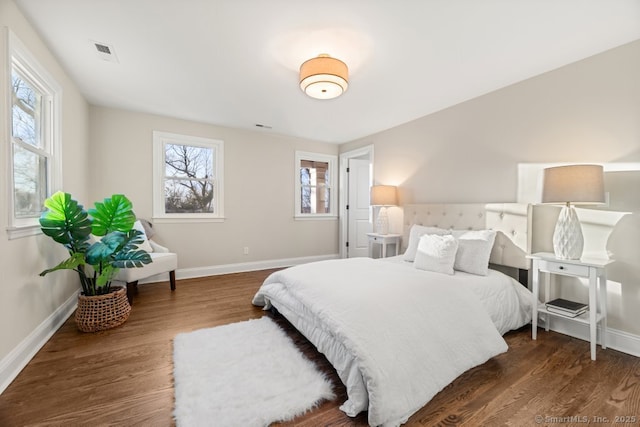 bedroom with dark hardwood / wood-style floors