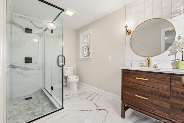 bathroom featuring vanity, toilet, and a shower with door