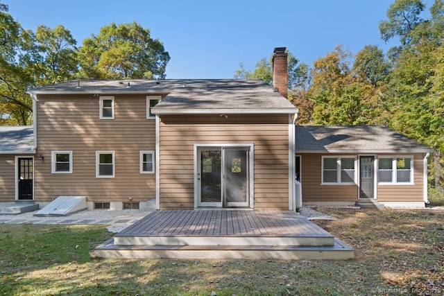 back of house with a deck and a yard