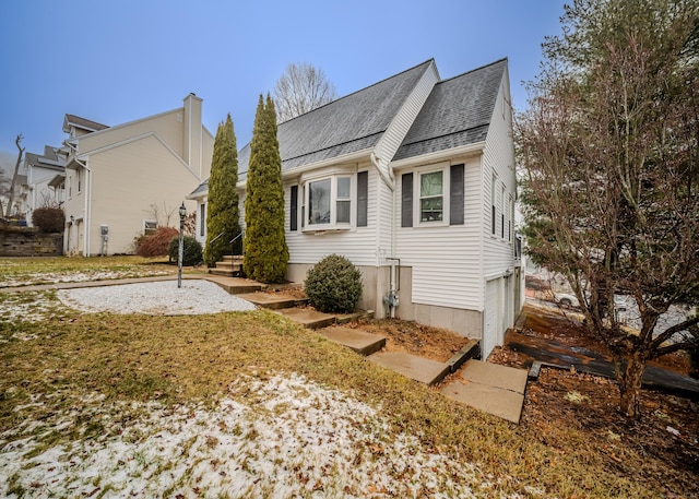 view of side of home featuring roof with shingles