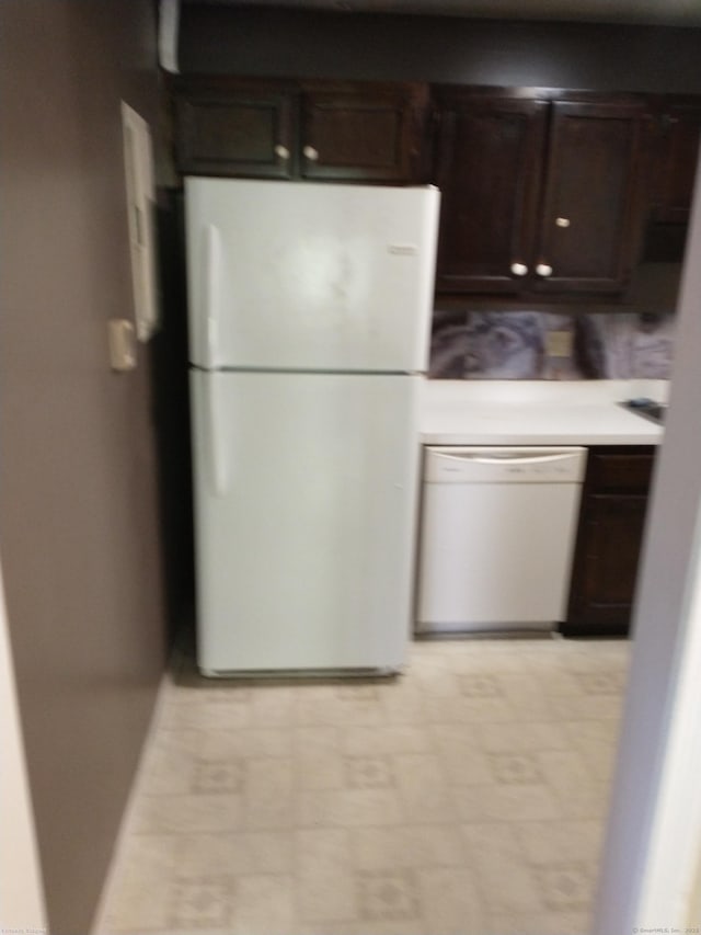 kitchen featuring white appliances and dark brown cabinetry