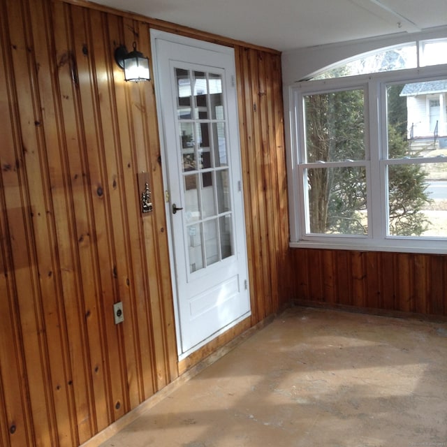 doorway to outside featuring wood walls