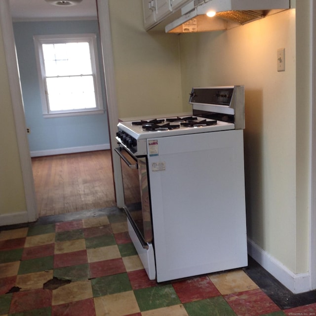 kitchen featuring white cabinetry, extractor fan, and range with gas cooktop