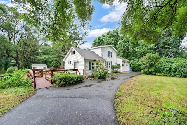 view of front of property with a front yard and a wooden deck