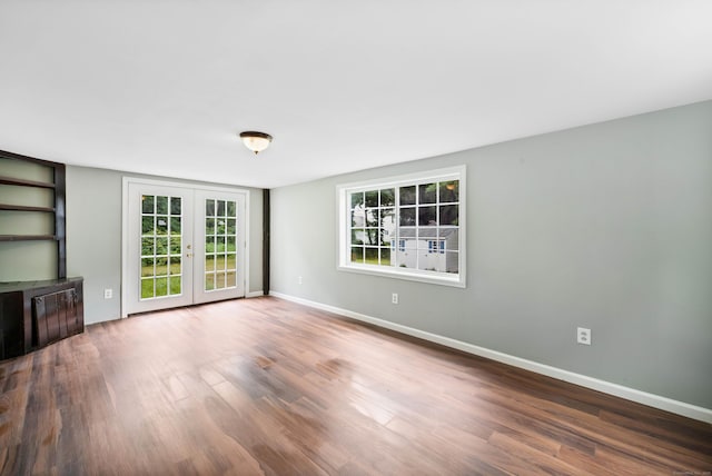 unfurnished living room featuring french doors and wood-type flooring