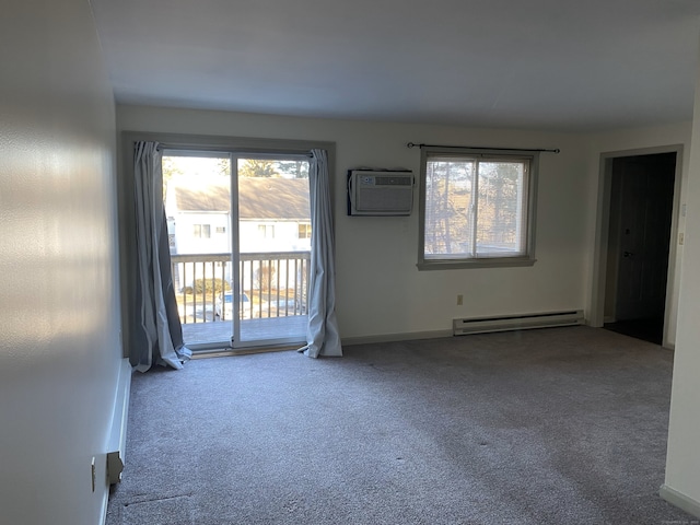 carpeted spare room with a baseboard heating unit and an AC wall unit