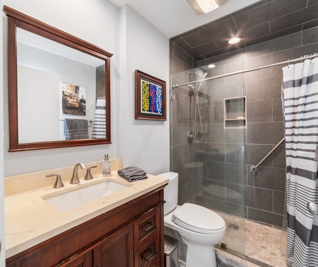 bathroom featuring vanity, toilet, and walk in shower